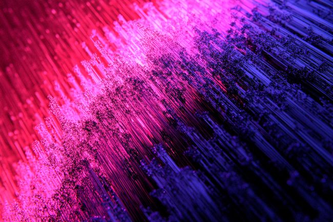 A gradient of pink and purple textures glowing at the center, fading into black edges with fine-grain textures.