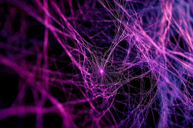A sprawling web of faintly illuminated threads, with one glowing thread weaving through the network, symbolizing a narrow path of understanding in AI's complexity.